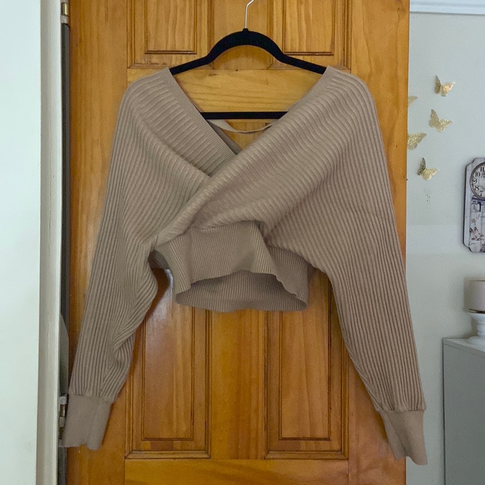 Crossover cropped sweatshirt. Size L. Cuff sleeves with strap across back.